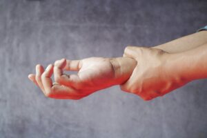 Patient holding wrist in pain